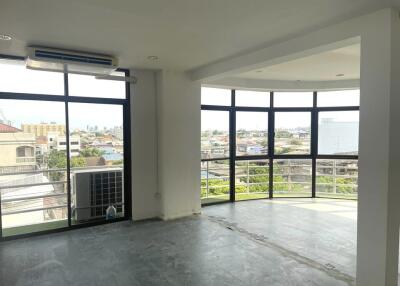 spacious living room with large windows and city view