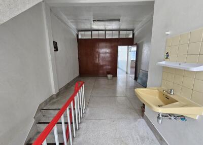 Indoor hallway with sink and staircase