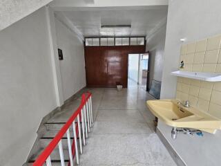 Indoor hallway with sink and staircase