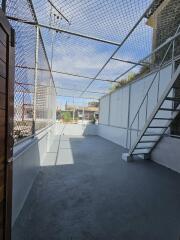 Secured outdoor area with netting and stairway