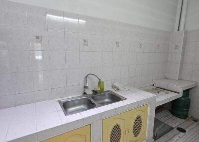 Spacious kitchen with double sink and tiled backsplash