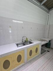 Spacious kitchen with double sink and tiled backsplash