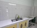 Spacious kitchen with double sink and tiled backsplash