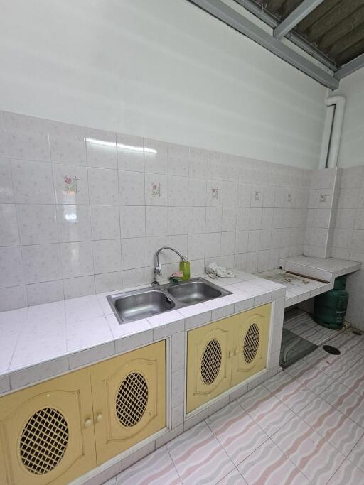 Spacious kitchen with double sink and tiled backsplash