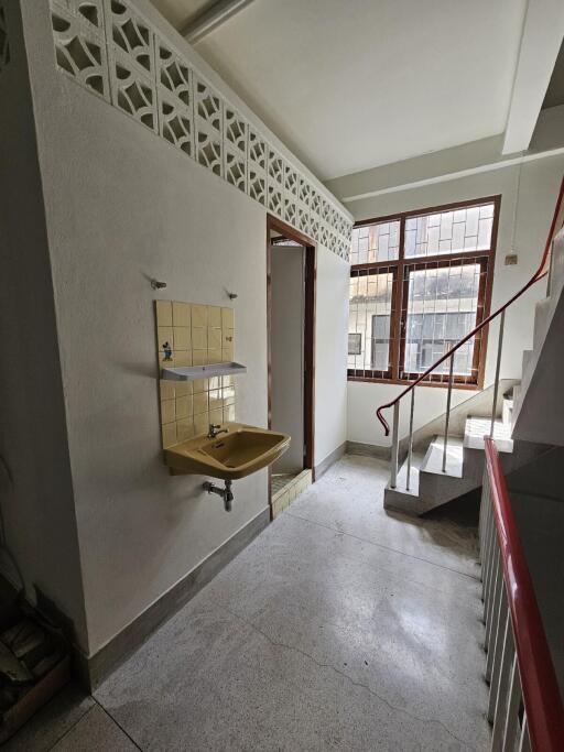 Hallway with staircase and sink