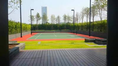 Outdoor tennis court with surrounding greenery