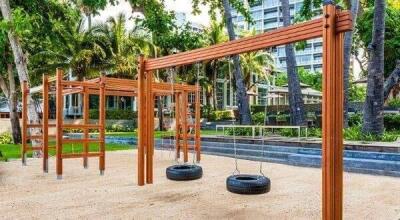 Outdoor playground with tire swings and wooden structures