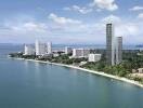 Aerial view of coastal city with skyscrapers and coastline