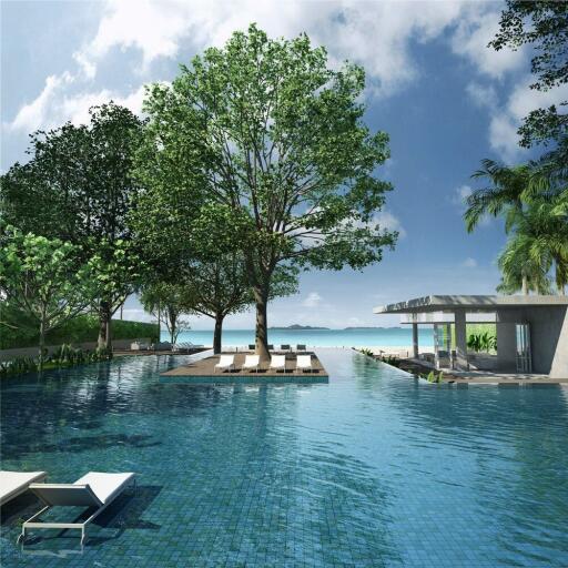 Luxury resort pool area with lounge chairs and trees overlooking the ocean