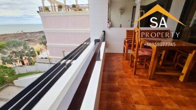 A balcony with a sea view and outdoor dining set