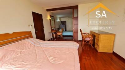 Bedroom with hardwood floors and wooden furniture