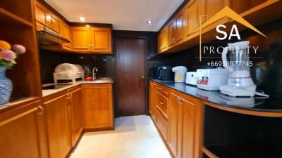 Modern kitchen with wooden cabinetry and appliances