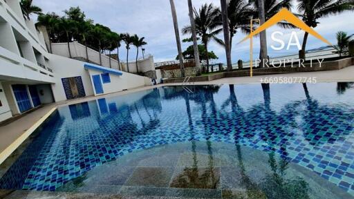 Spacious outdoor swimming pool with surrounding palm trees