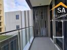 Spacious balcony with glass railing and city view