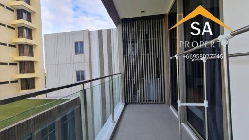 Spacious balcony with glass railing and city view