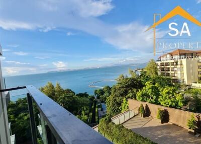 Balcony view overlooking the sea and nearby buildings