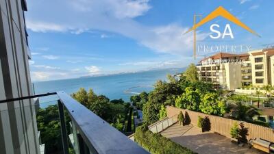 Balcony view overlooking the sea and nearby buildings