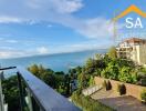 Balcony view overlooking the sea and nearby buildings