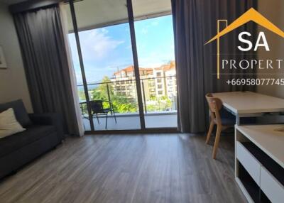 Living room with a view of a balcony and buildings