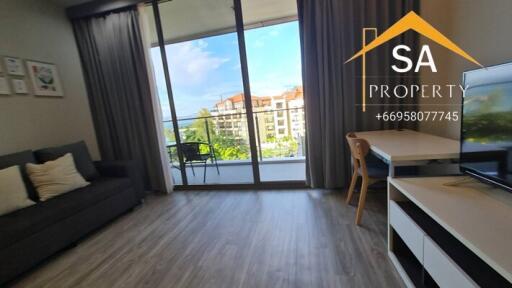 Living room with a view of a balcony and buildings