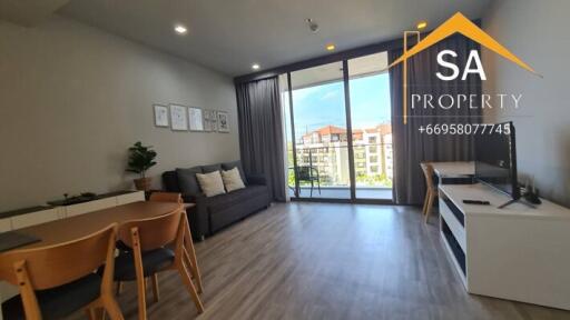 Modern living room with large glass doors overlooking a balcony