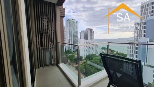 City and ocean view from a balcony with chair