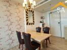 Dining area with a floral feature wall and a chandelier