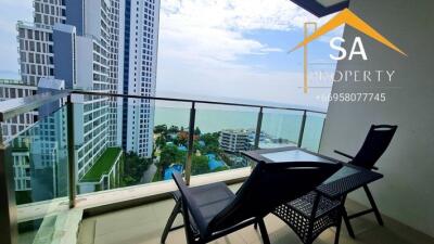 Spacious balcony with outdoor seating and panoramic city and sea view