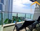 Spacious balcony with outdoor seating and panoramic city and sea view