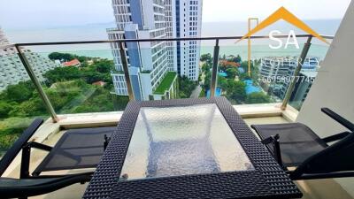 Modern balcony with glass railing overlooking urban and sea view