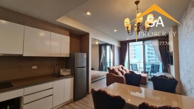 Modern apartment living area with adjoining kitchen and dining space