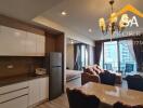 Modern apartment living area with adjoining kitchen and dining space