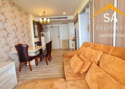 Spacious living room and dining area with brown couch and dining table