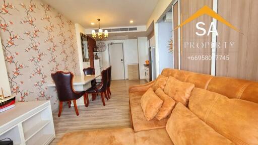 Spacious living room and dining area with brown couch and dining table