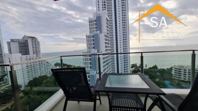 Balcony with seating area and sea view in high-rise building