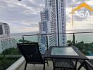 Balcony with seating area and sea view in high-rise building