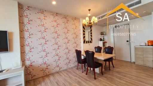 Dining room with floral wallpaper and chandelier