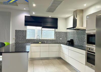 Modern kitchen with white cabinetry and granite countertops