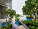 Modern outdoor area with pool and garden overlooking cityscape