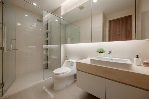 Modern bathroom with glass shower enclosure and vanity