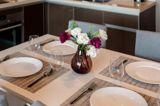 Modern kitchen dining area with a table set for four