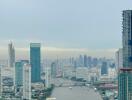 Scenic view of a river flowing through the city with high-rise buildings