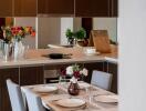 Modern kitchen with dining area and fresh flowers on the table