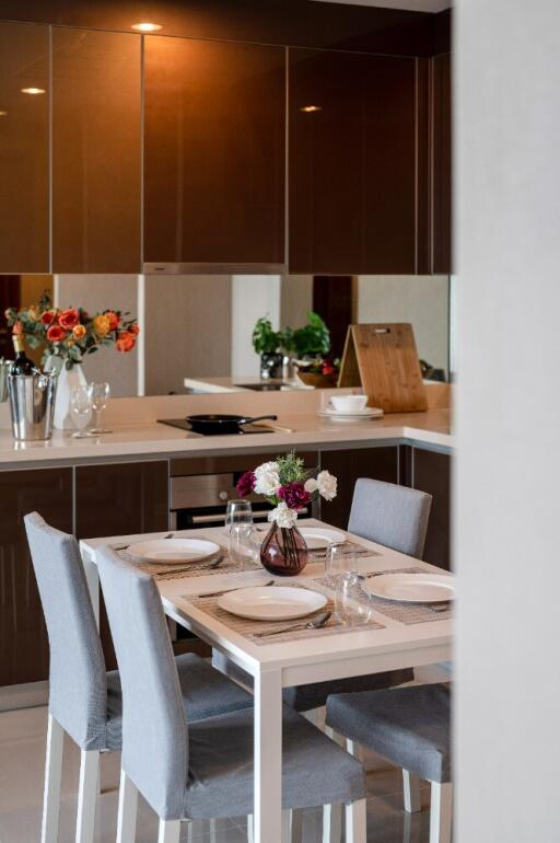 Modern kitchen with dining area and fresh flowers on the table