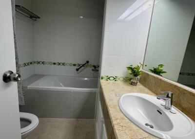 Modern bathroom with a bathtub, sink, and toilet