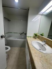 Modern bathroom with a bathtub, sink, and toilet