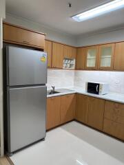 Modern kitchen with wooden cabinets and stainless steel appliances