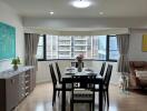 Dining area with a table set for six, large window, and modern furnishings