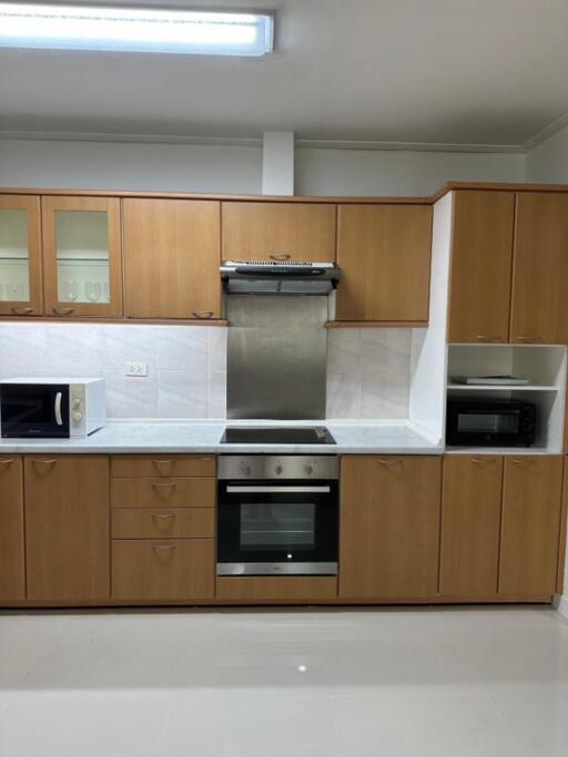 Modern kitchen with wooden cabinets and stainless steel appliances