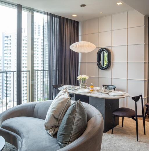 Modern living room with a dining area and large windows